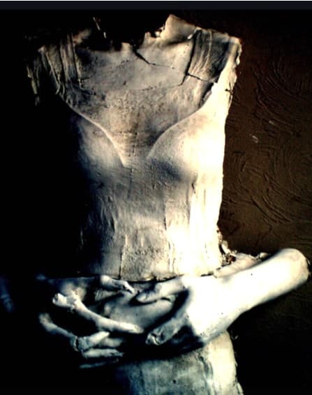 A sculpted torso holding cast hands, from the collection