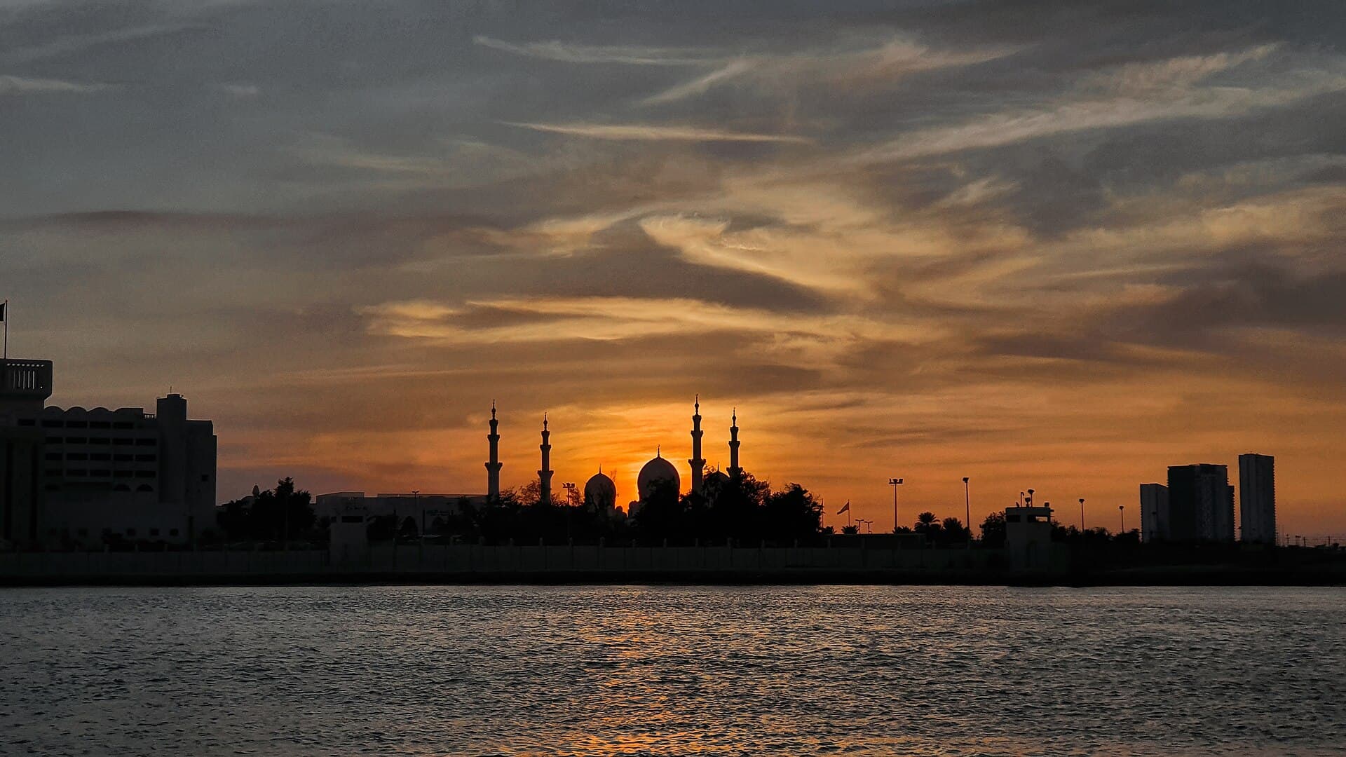 A mosque in silhouette against the sunset